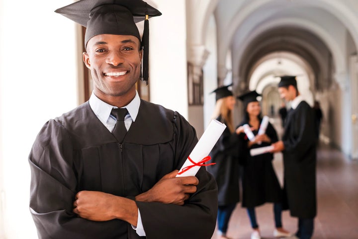 college graduate holding his diploma | Subaru of Naples in Naples FL