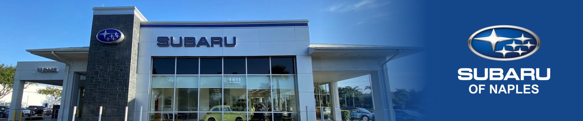 Low angle perspective shot of Subaru of Naples dealership on a sunny day.