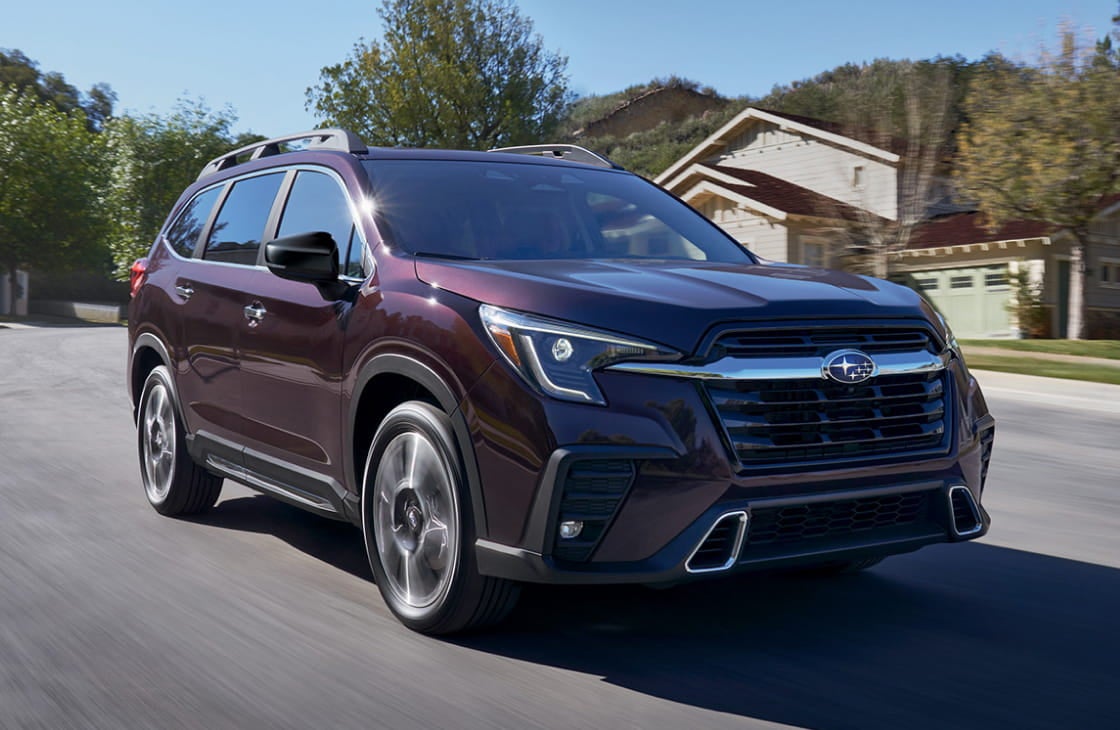 Subaru Ascent driving along a residential road, shown from a front three-quarter angle.