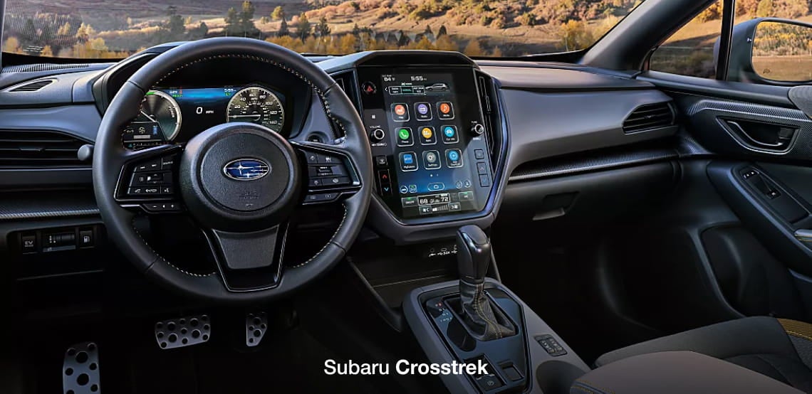 Subaru Crosstrek interior featuring the steering wheel, instrument cluster, center touchscreen, and gear selector.