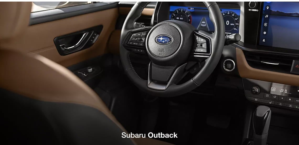 Subaru Outback interior featuring the steering wheel, digital instrument cluster, infotainment display, and brown interior accents.